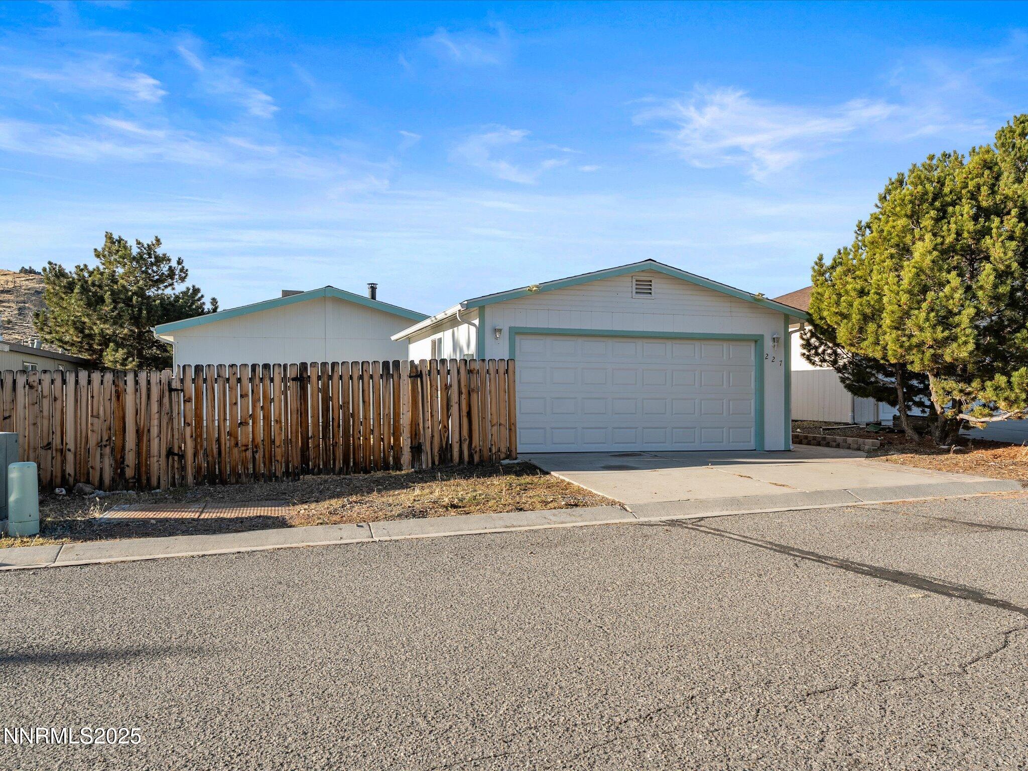227 Walker Street Gardnerville, NV 89410 - Photo 4 of 33 a front view of a house with a yard and garage