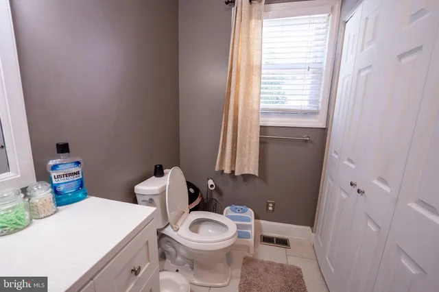a white toilet sitting next to a bathroom sink