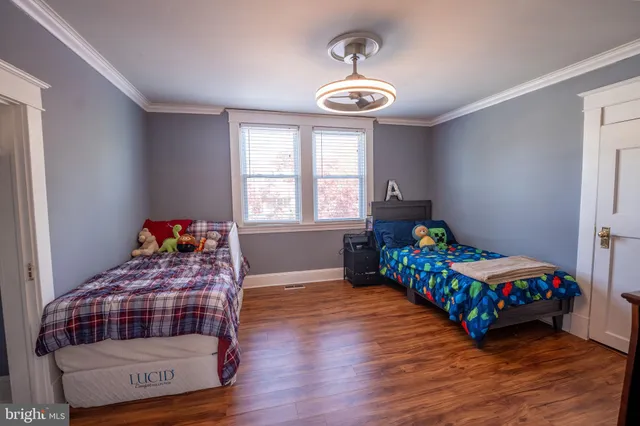 a bedroom with two beds and a chandelier