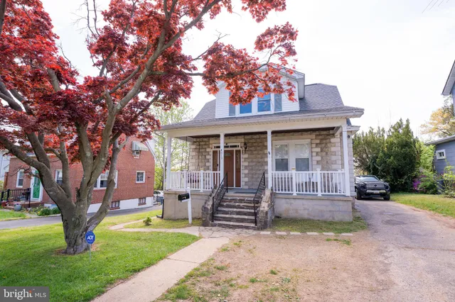 a front view of a house with garden and porch