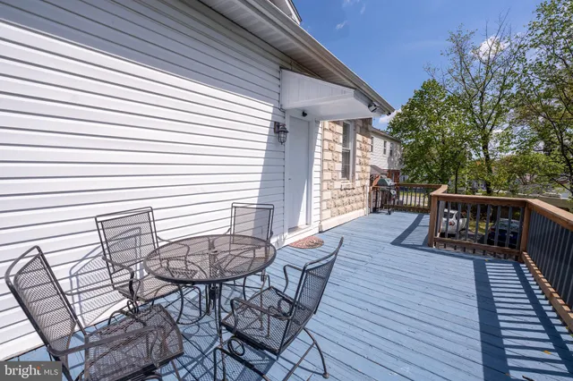 a view of deck with wooden floor and fence and a floor to ceiling window