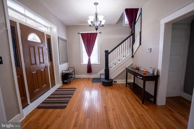 a view of entryway with wooden floor and stairs