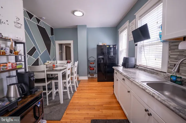 a kitchen with stainless steel appliances granite countertop a sink a stove and a refrigerator