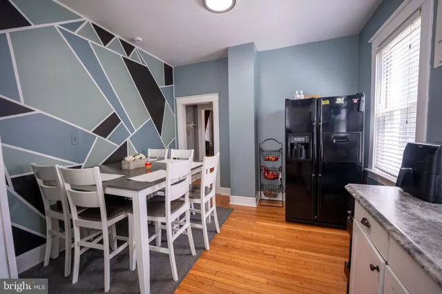 a kitchen with granite countertop lots of wooden furniture and stainless steel appliances
