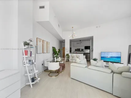 a living room with furniture and a chandelier