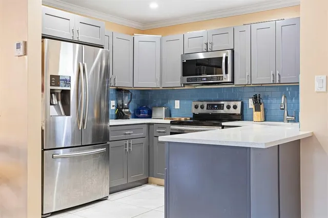 a kitchen with stainless steel appliances a refrigerator stove and microwave