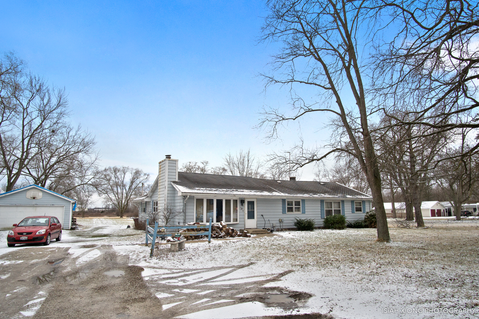 2091 Bilter Road Aurora, IL 60502 - Photo 2 of 4 a patio with a table and chairs under an umbrella