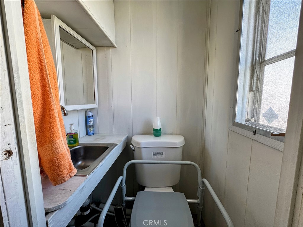3734 Pacific Street, Unit 40 Highland, CA 92346 - Photo 14 of 15 a bathroom with a sink toilet and window