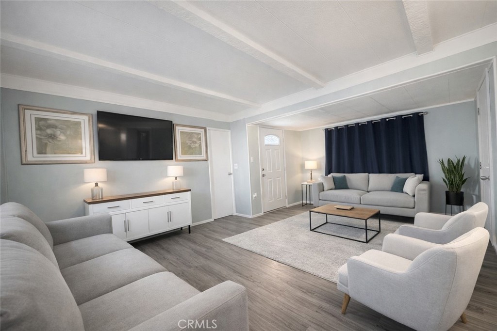 3734 Pacific Street, Unit 40 Highland, CA 92346 - Photo 3 of 15 a living room with furniture and a flat screen tv