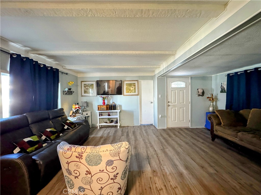 3734 Pacific Street, Unit 40 Highland, CA 92346 - Photo 4 of 15 a living room with furniture and wooden floor