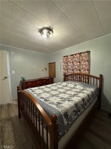 a bed sitting in a bedroom and a table