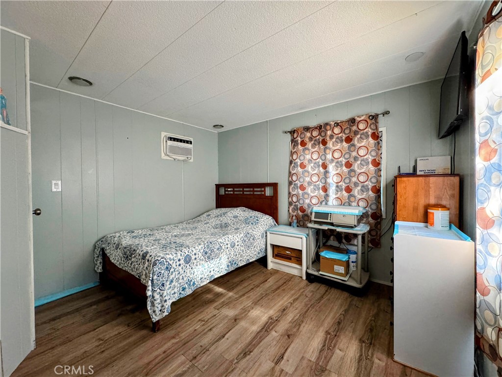 3734 Pacific Street, Unit 40 Highland, CA 92346 - Photo 7 of 15 a bedroom with a bed and a tv on table