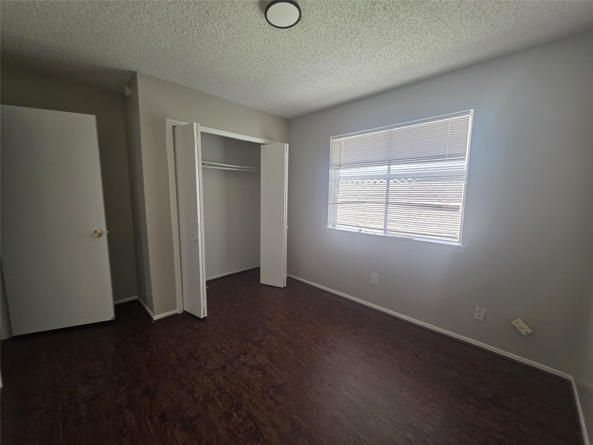 23322 Dew Wood Lane Spring, TX 77373 - Photo 16 of 20 an empty room with wooden floor closet and windows