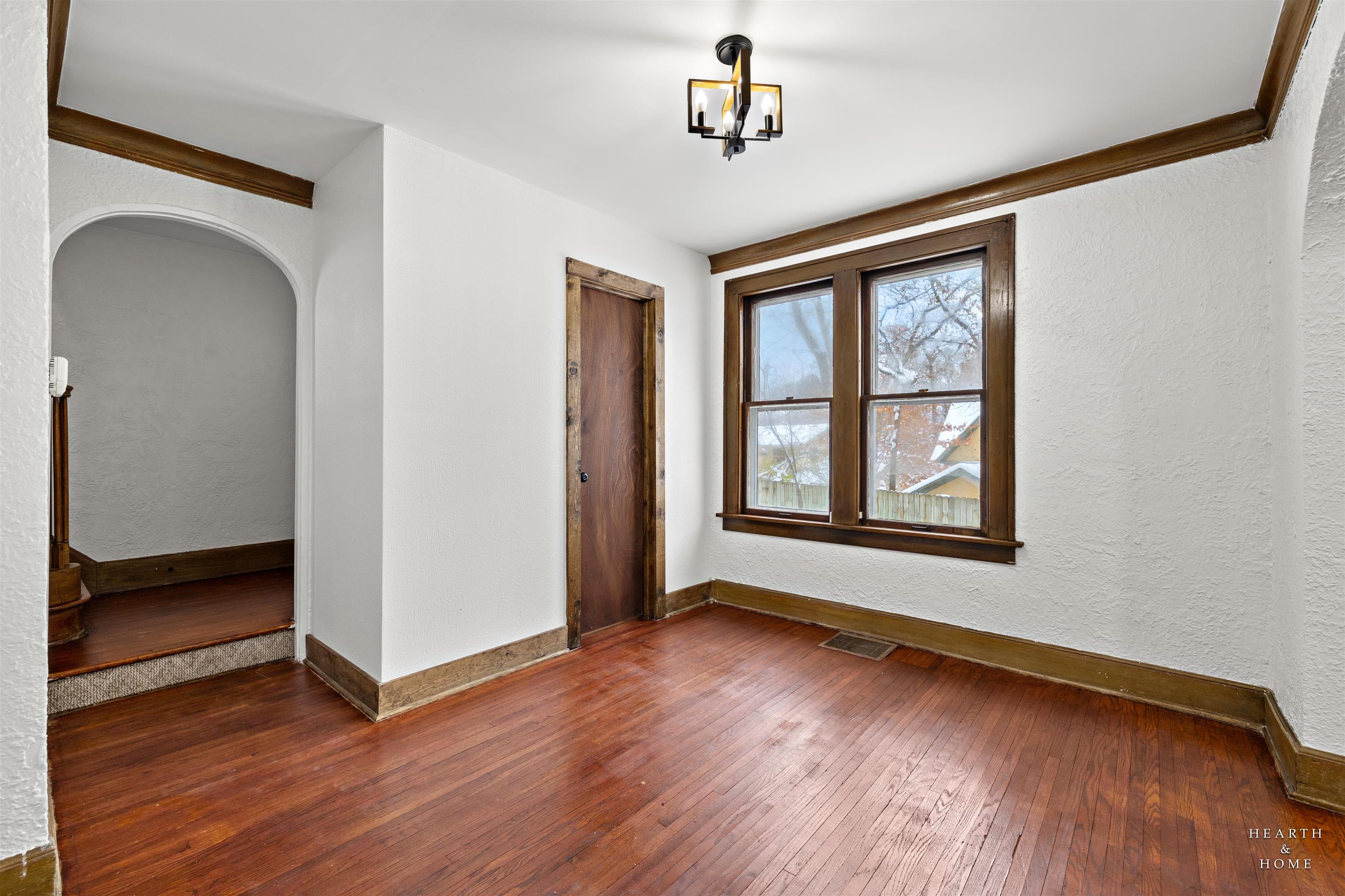 1016 B Street Rockford, IL 61107 - Photo 7 of 38 an empty room with wooden floor chandelier and windows