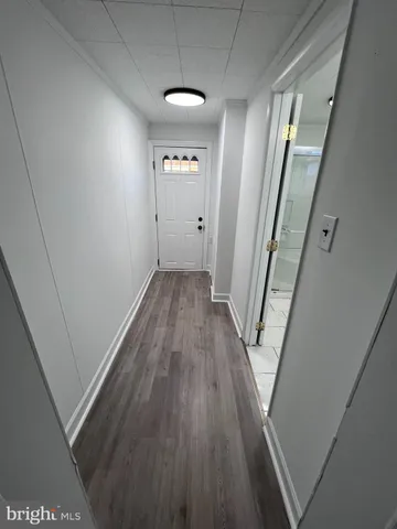 wooden floor in an empty room with a mirror