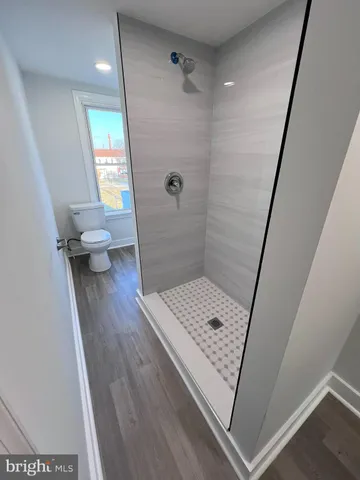 a view of bathroom with a shower and toilet