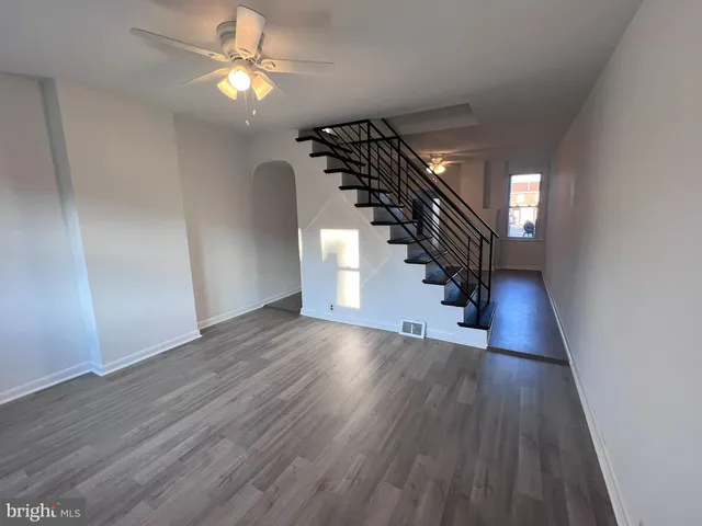 a view of entryway and hall with wooden floor