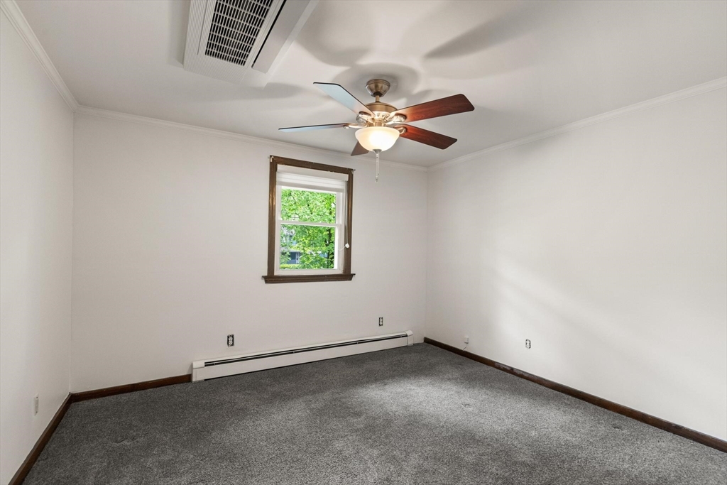 901 Haverhill Street Rowley, MA 01969 - Photo 26 of 42 an empty room with a window and a fan