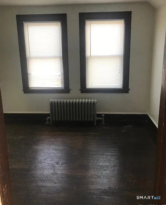 23 # 3 Clinton Avenue Middletown, CT 06457 - Photo 6 of 7 a view of an empty room with wooden floor and a window
