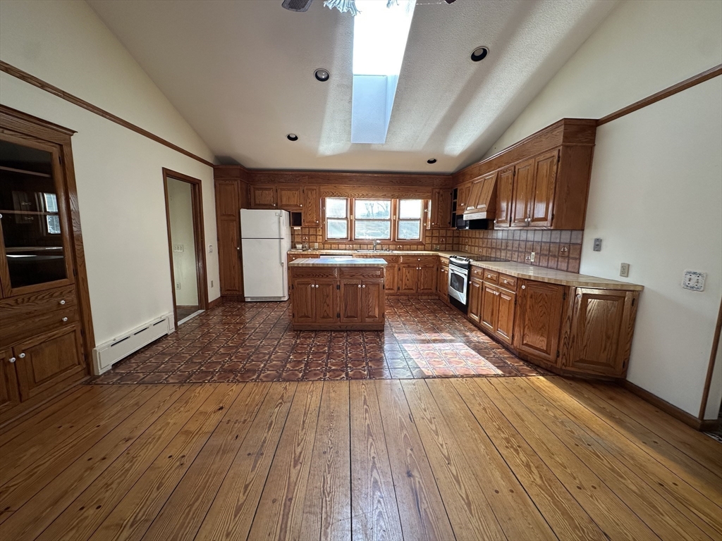 124 Barrington Road Longmeadow, MA 01106 - Photo 8 of 13 a large kitchen with wooden floors and stainless steel appliances