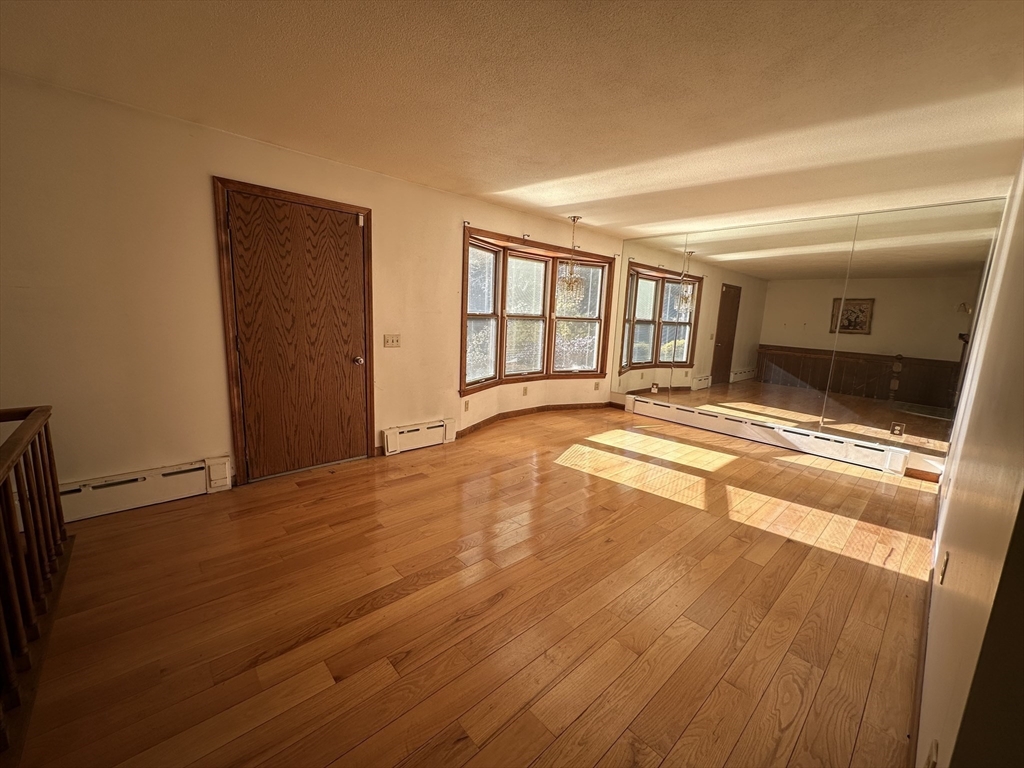 124 Barrington Road Longmeadow, MA 01106 - Photo 9 of 13 a view of an empty room with wooden floor and a window
