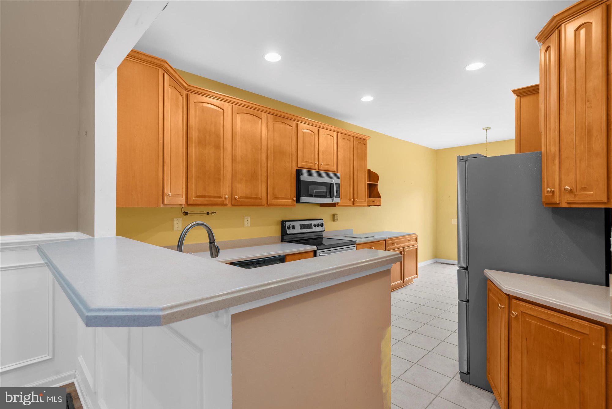 813 Geranium Drive Warrington, PA 18976 - Photo 12 of 44 a kitchen with stainless steel appliances a refrigerator sink and cabinets