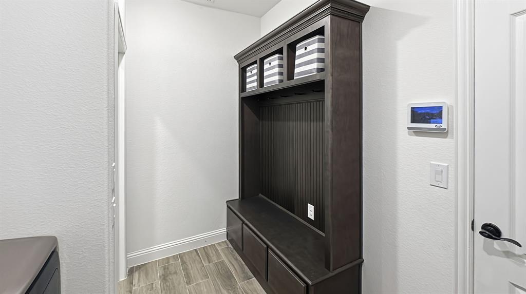 5216 Troupe Road McKinney, TX 75071 - Photo 38 of 40 Built-in mudroom bench and storage unit featuring beadboard backing and upper cubbies