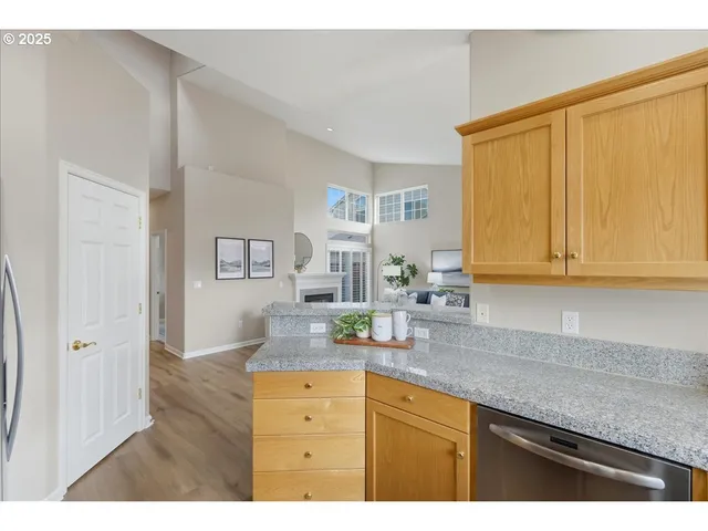 a kitchen with granite countertop white cabinets and sink