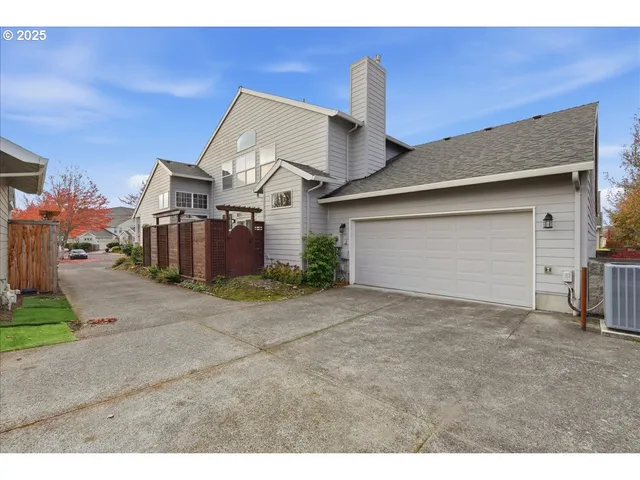 a view of a house with a backyard and garage