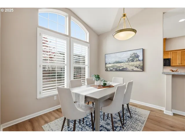 a view of a dining room with furniture and a window