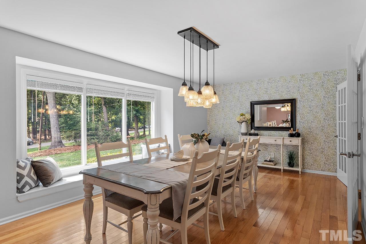 124 Bayleaf Drive Raleigh, NC 27615 - Photo 10 of 40 a view of a dining room with furniture wooden floor and chandelier