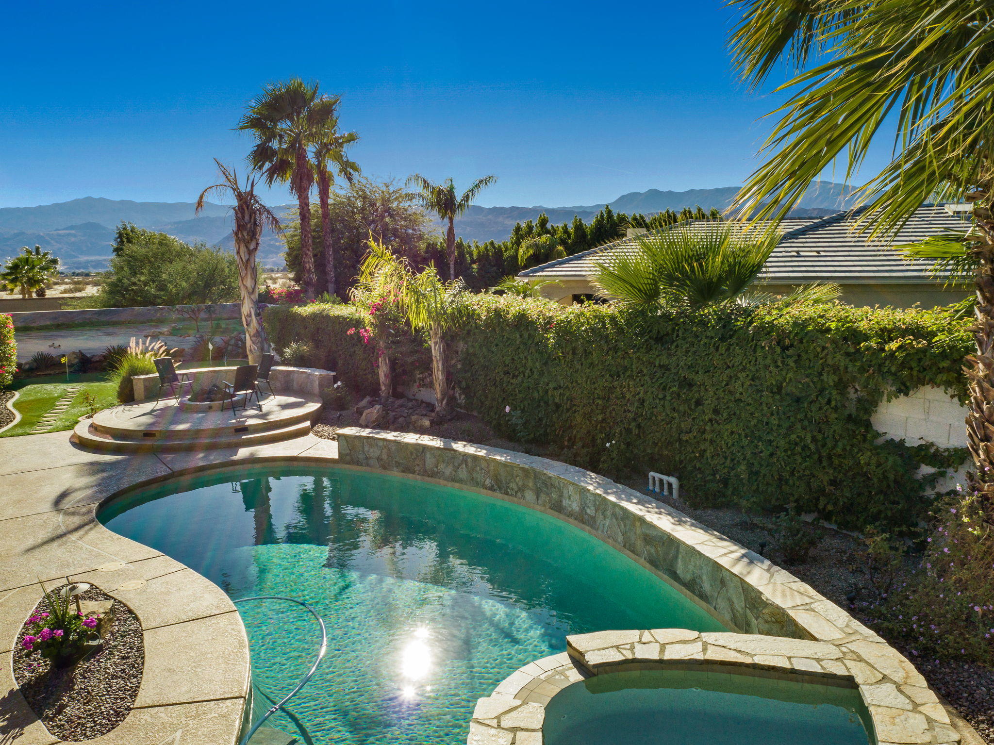 1 Orleans Road Rancho Mirage, CA 92270 - Photo 3 of 50 a view of a swimming pool with a yard