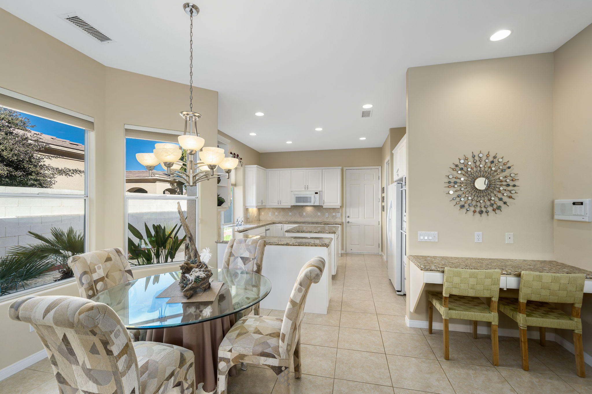 1 Orleans Road Rancho Mirage, CA 92270 - Photo 24 of 50 a view of a dining room and livingroom view with furniture wooden floor a chandelier