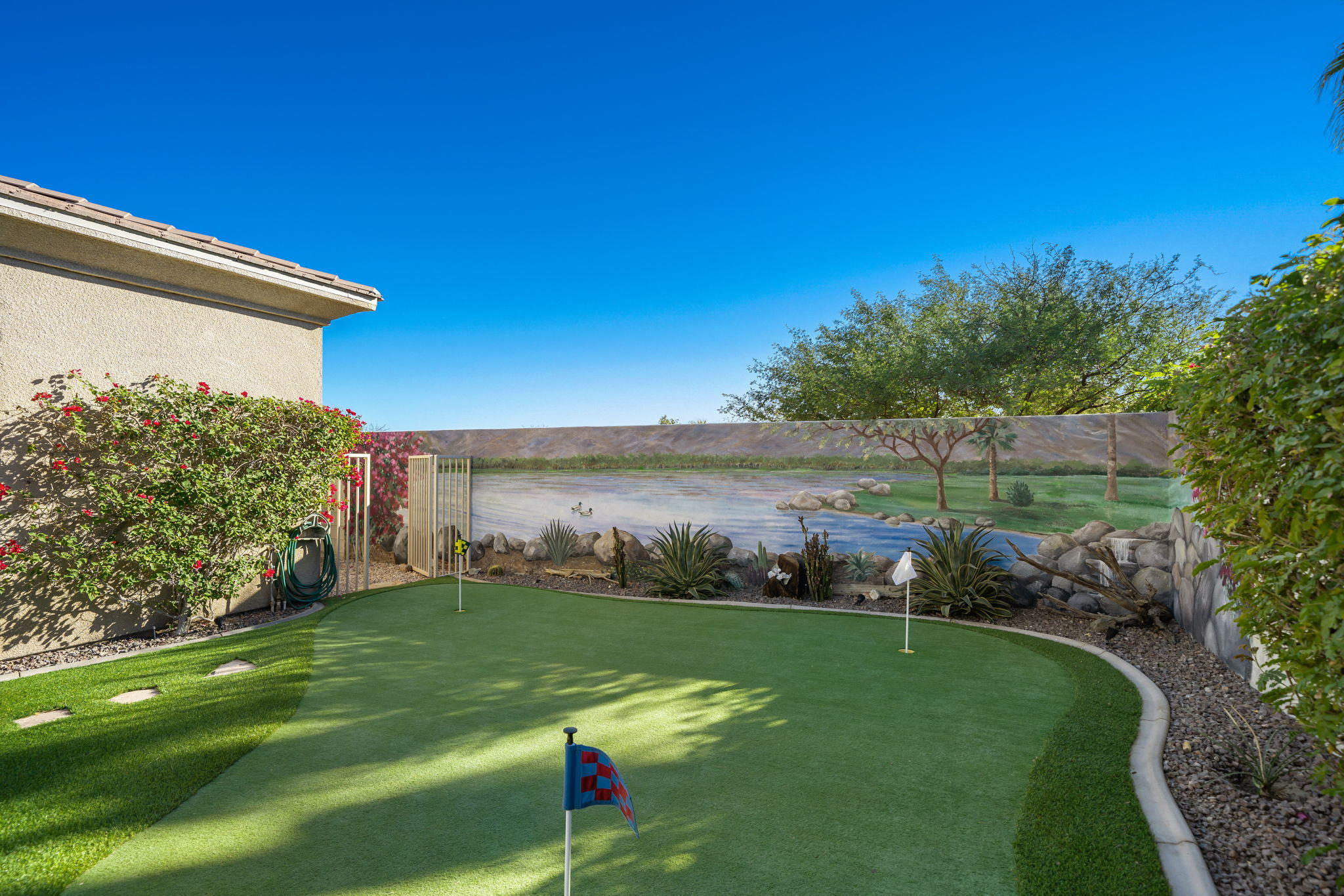 1 Orleans Road Rancho Mirage, CA 92270 - Photo 33 of 50 a view of a field of grass and a building in the background