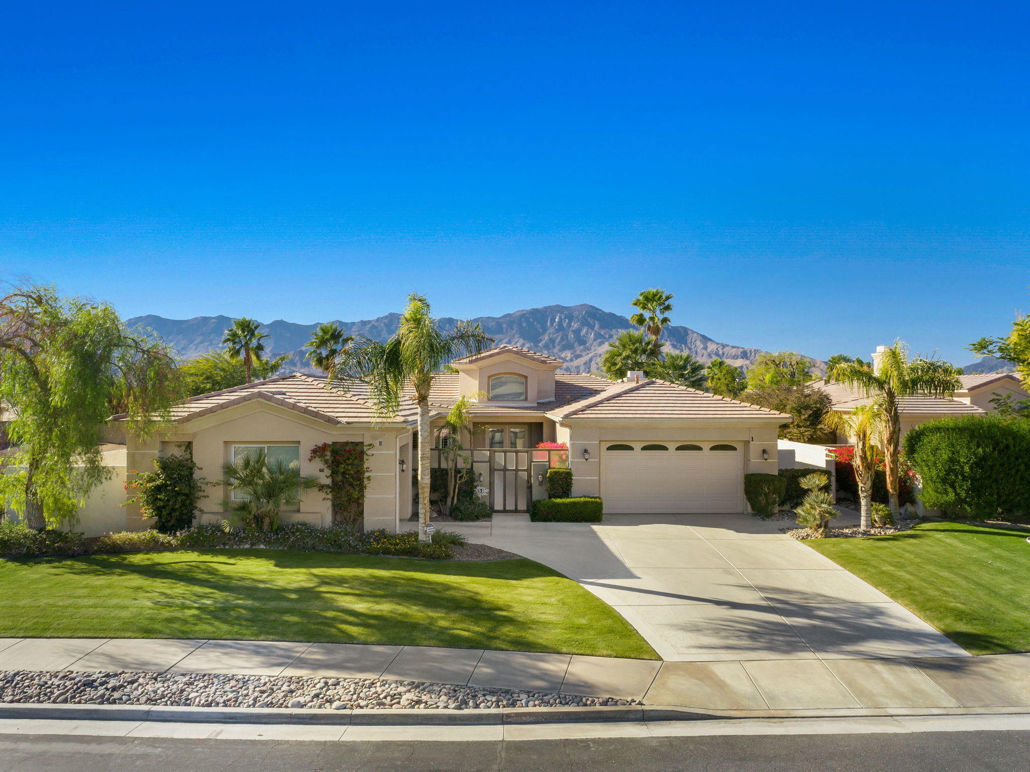 1 Orleans Road Rancho Mirage, CA 92270 - Photo 5 of 50 a front view of a house with a yard