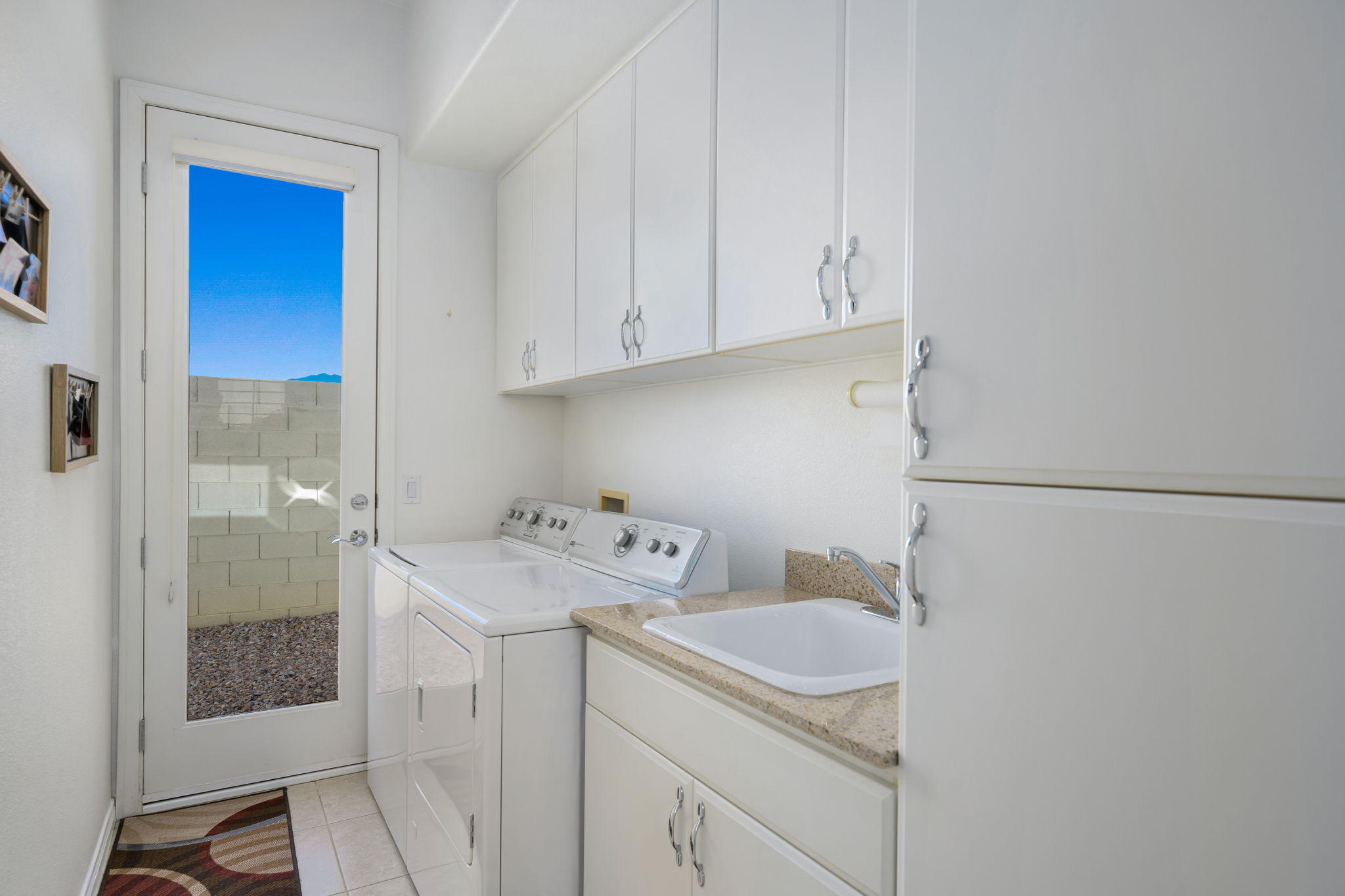 1 Orleans Road Rancho Mirage, CA 92270 - Photo 47 of 50 a utility room with cabinets washer and dryer