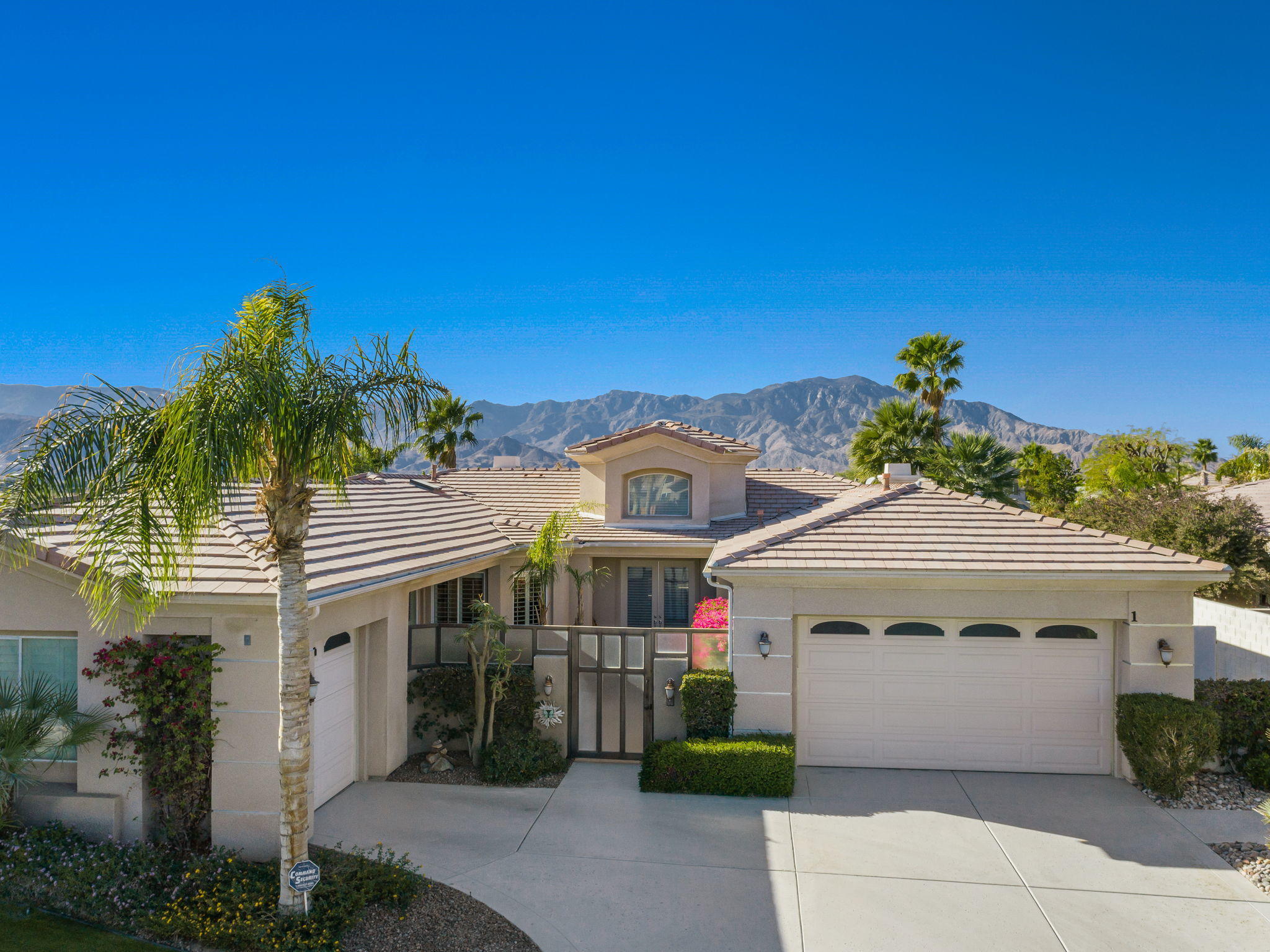 1 Orleans Road Rancho Mirage, CA 92270 - Photo 6 of 50 a front view of a house with a garden