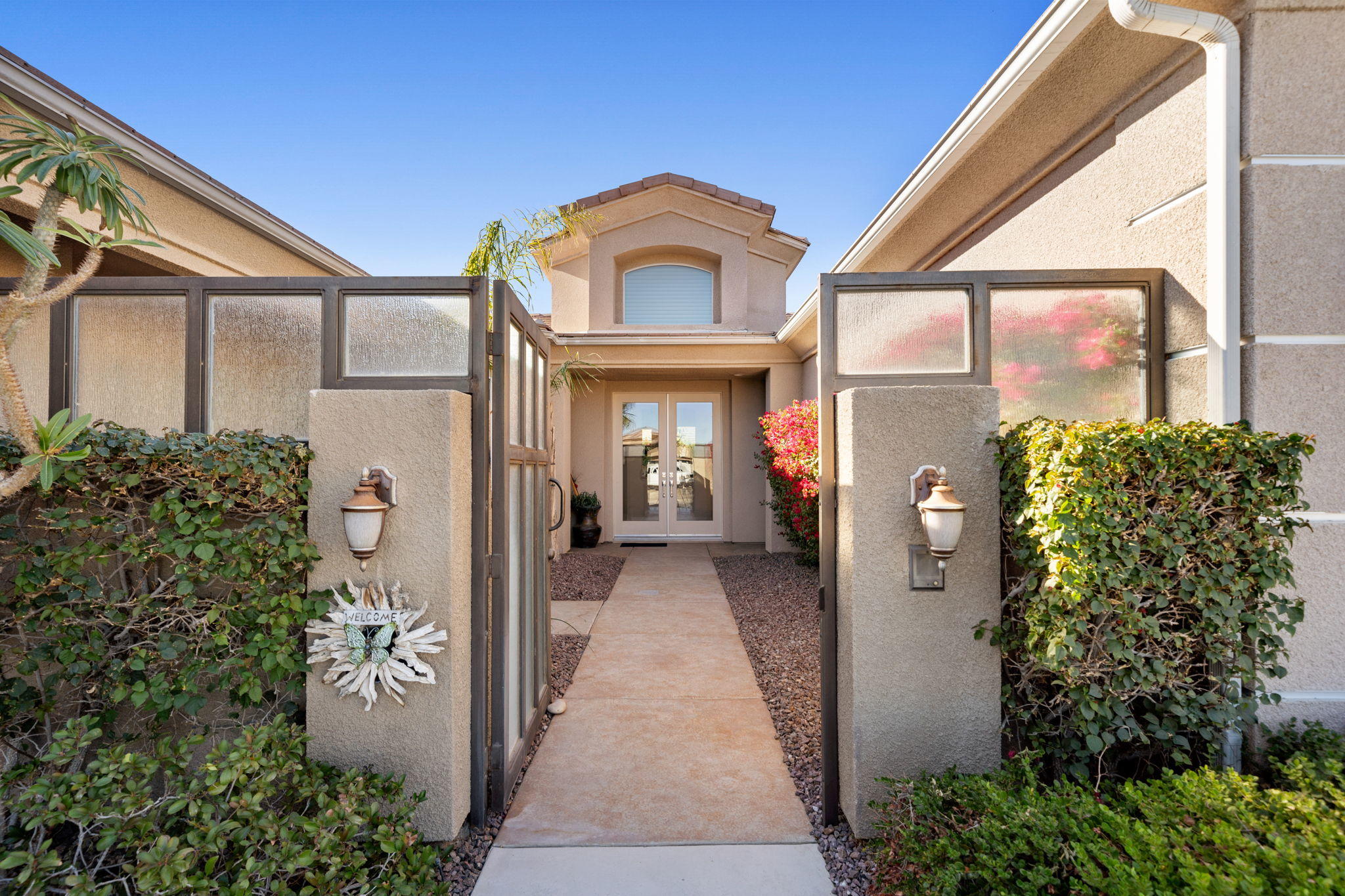 1 Orleans Road Rancho Mirage, CA 92270 - Photo 10 of 50 a view of a brick house with potted plants