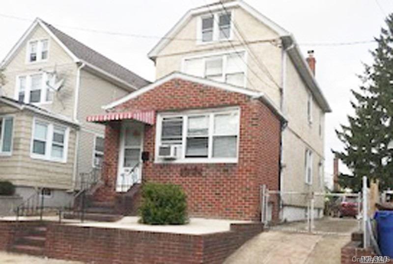 136-41 58th Road Queens, NY 11355 - Photo 1 of 1 a front view of a house with garden