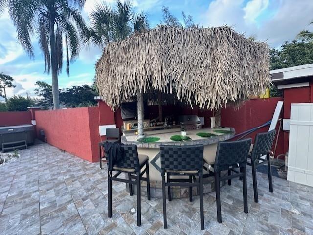 5800 Pine Tree Road Parkland, FL 33067 - Photo 22 of 35 a patio with table and chairs