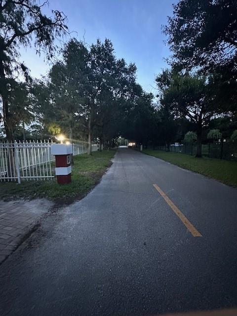 5800 Pine Tree Road Parkland, FL 33067 - Photo 32 of 35 a view of a road with a trees in the background