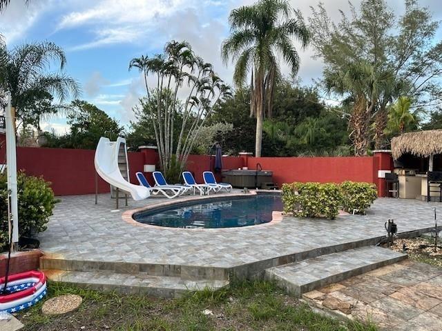 5800 Pine Tree Road Parkland, FL 33067 - Photo 5 of 35 a view of a water fountain in front of a house