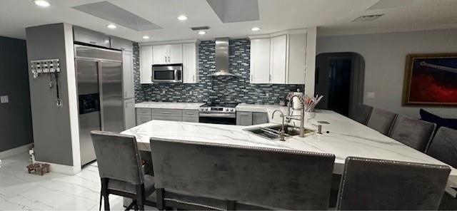 5800 Pine Tree Road Parkland, FL 33067 - Photo 9 of 35 a kitchen with a table chairs refrigerator and microwave
