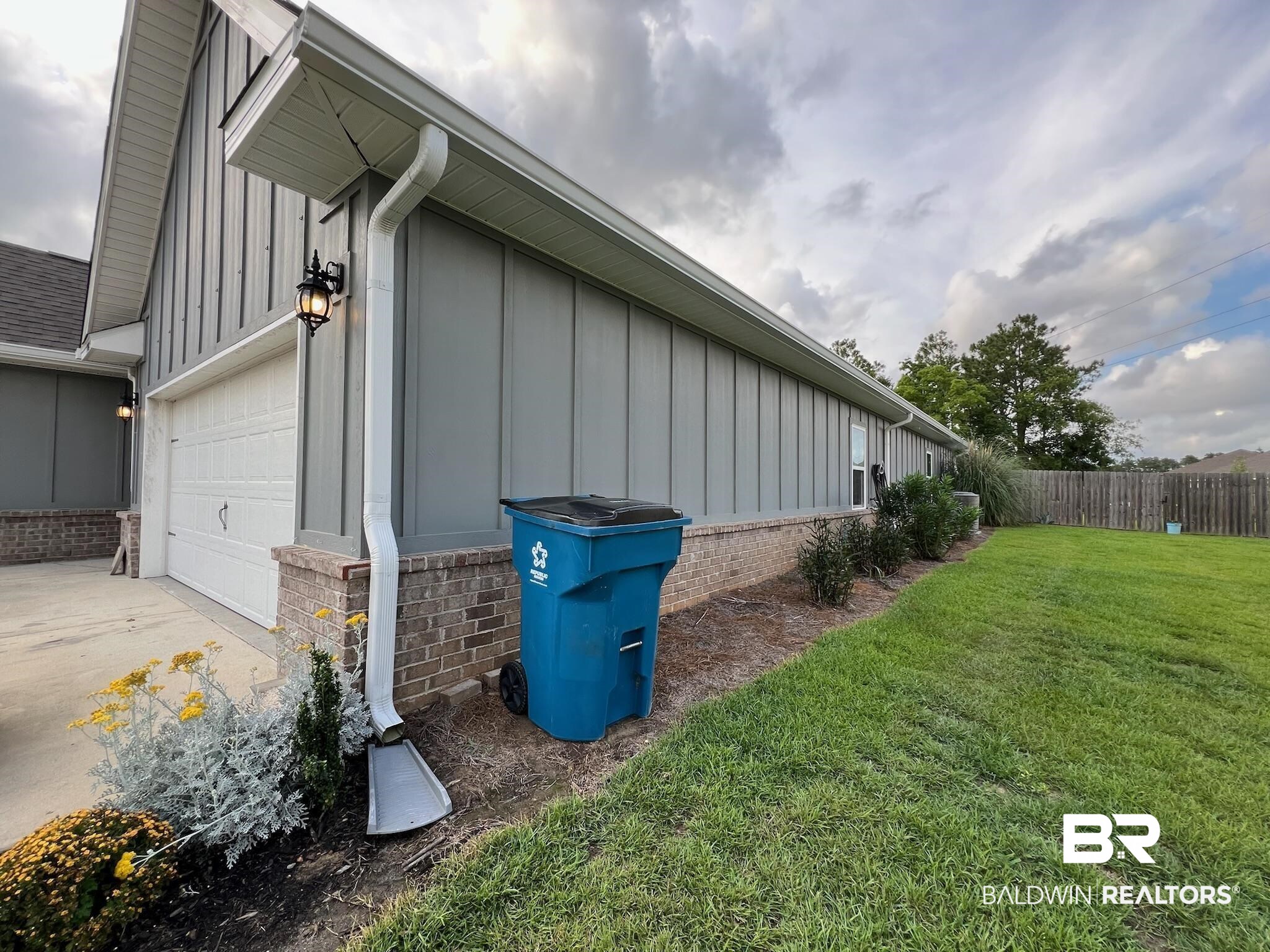 3904 Conrad Court Gulf Shores, AL 36542 - Photo 23 of 24 View of side of property with a garage and a yard