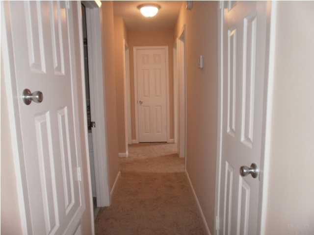 5185 Flax Road Pensacola, FL 32504 - Photo 11 of 25 This is a "T" shaped hallway which leads to the four bedrooms. First door to right is the coat closet and the Linen closet at the end of the hall.