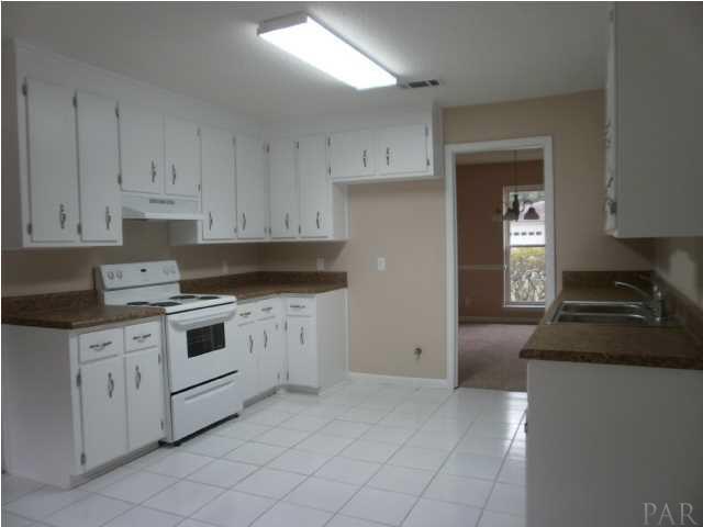 5185 Flax Road Pensacola, FL 32504 - Photo 6 of 25 All white kitchen with new range, hood, dishwasher, and disposal.