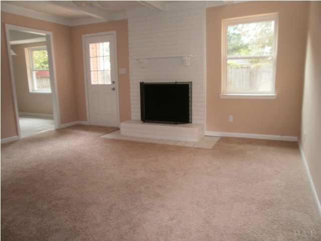 5185 Flax Road Pensacola, FL 32504 - Photo 10 of 25 Family Room has a Brick Fireplace with new carpet. This Family Room has a raised ceiling with beams.