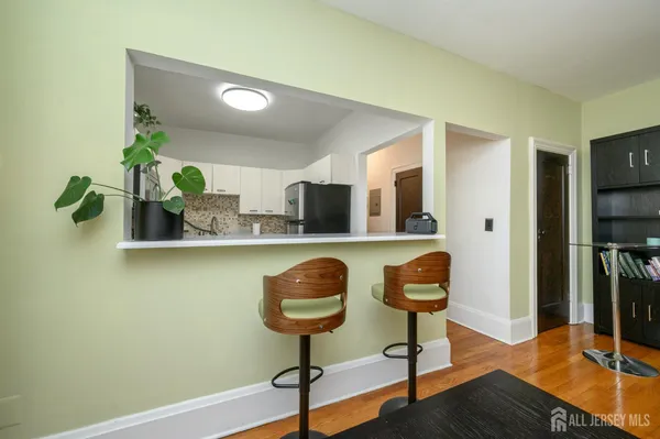 a view of a hallway with furniture and a window