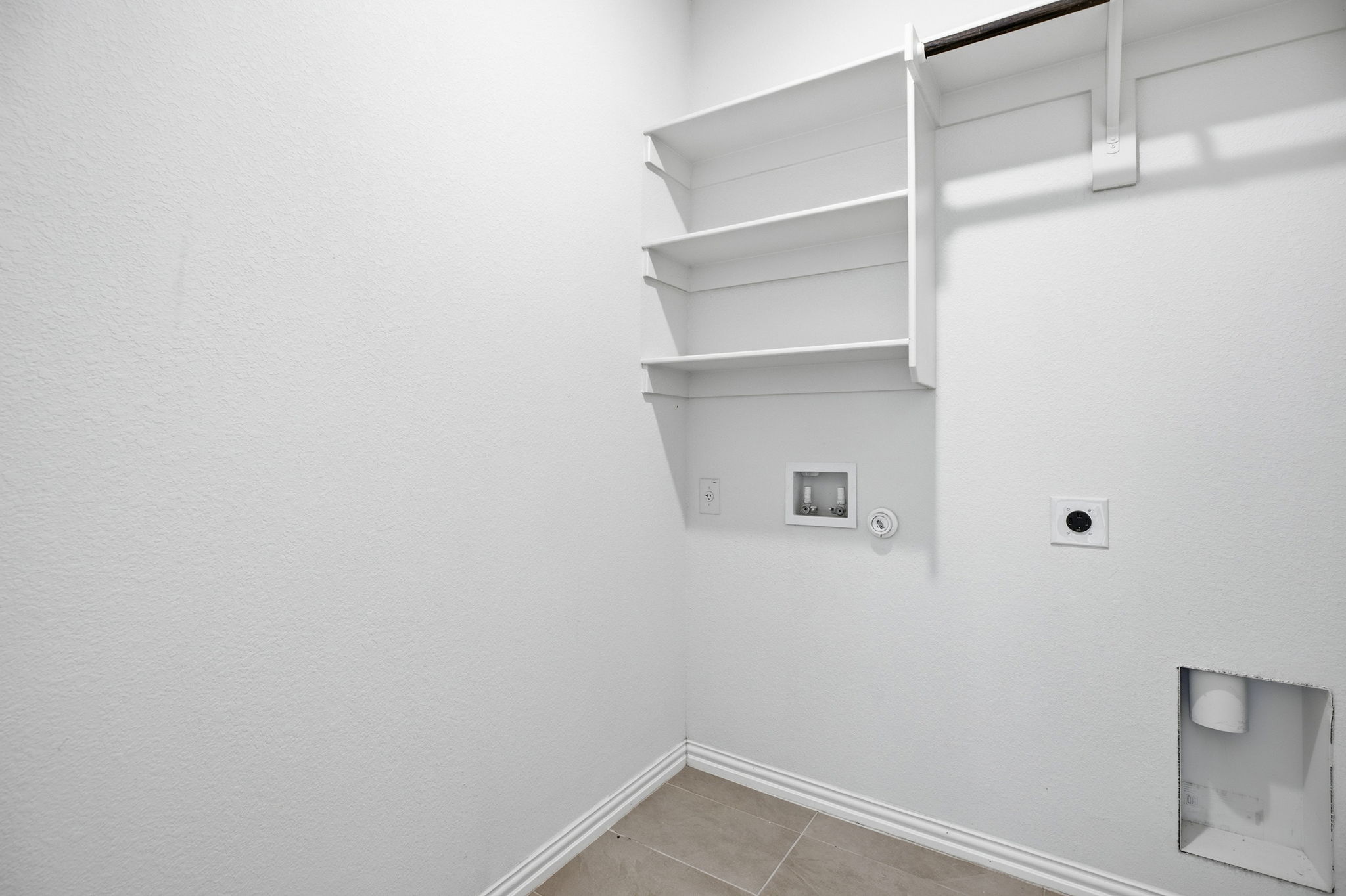 13720 Jon Ryan Road Manor, TX 78653 - Photo 18 of 31 Functional laundry space featuring convenient shelving and essential utility hookups.