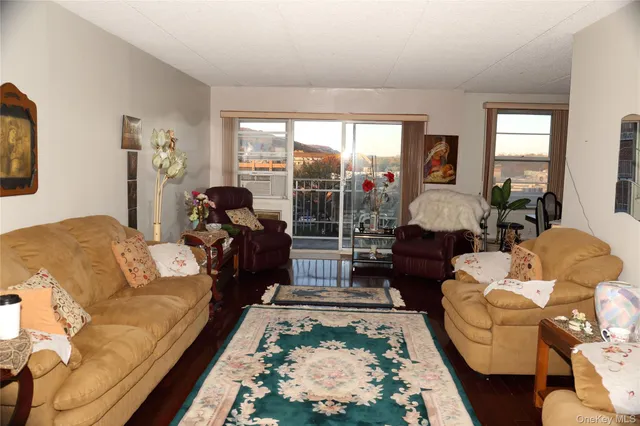 a living room with furniture fireplace and a large window